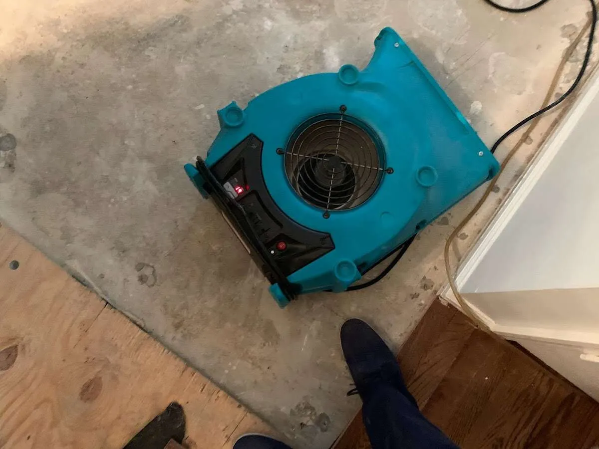 Air mover drying subfloor during Commercial Water Damage Restoration in Pleasant Prairie